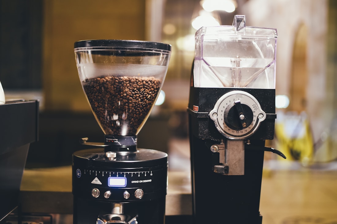 Commercial coffee grinders filled with beans
