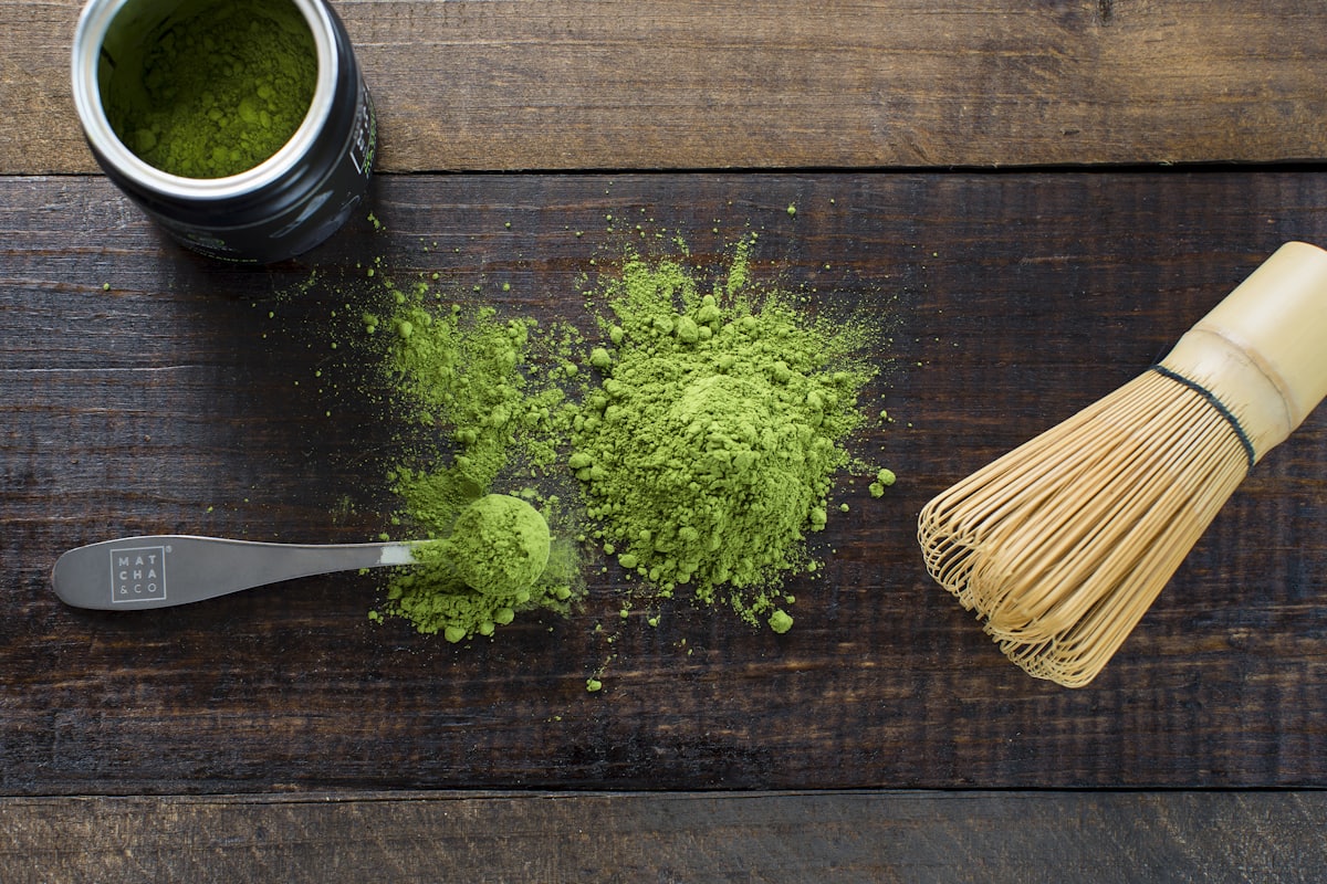 Matcha green tea powder with a bamboo whisk